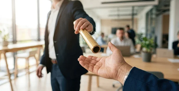 One person handing a baton to another